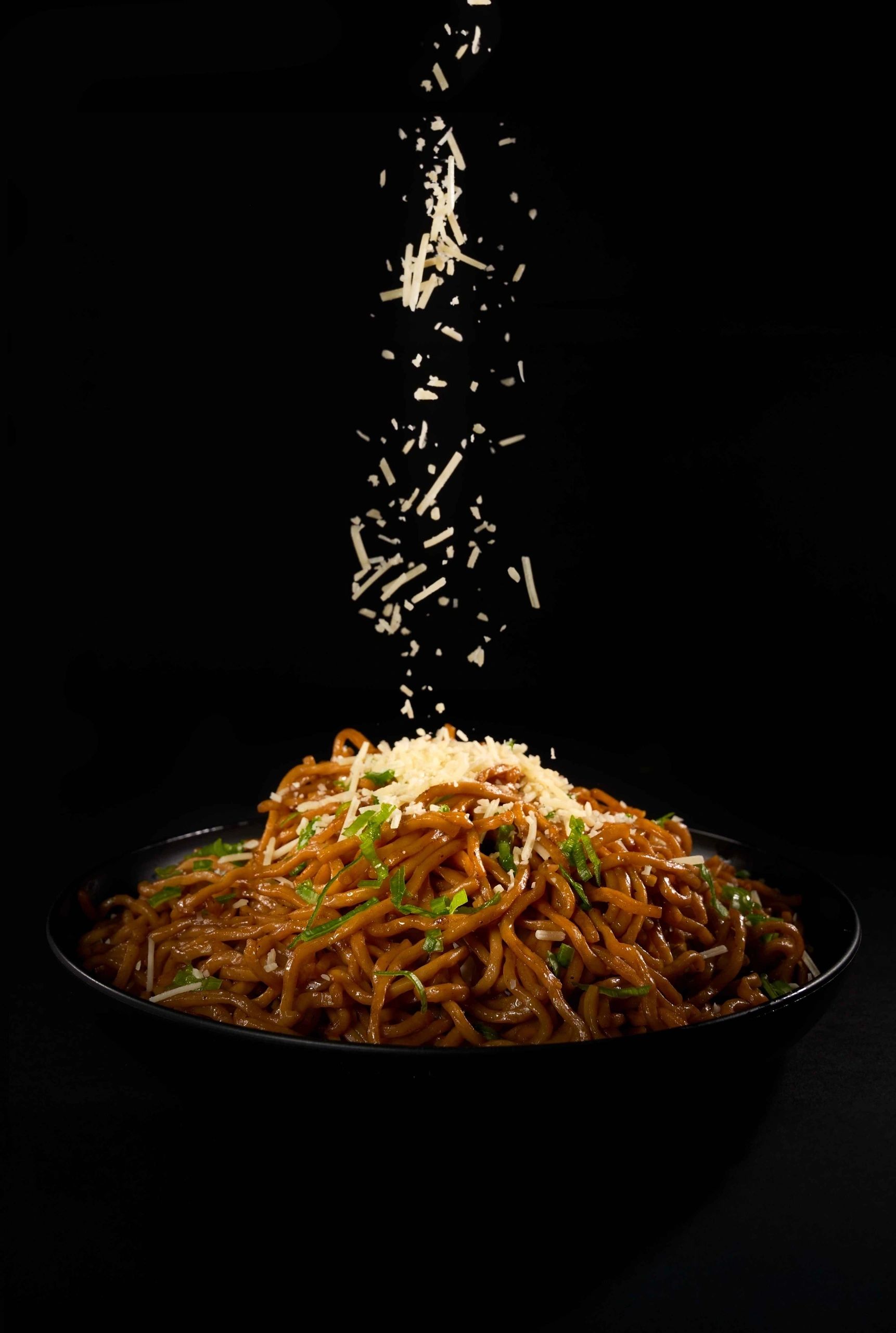 Taking a photo of the Chinese food inside the plate with a camera